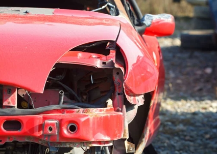 Close up of a damaged red sedan after a car accident