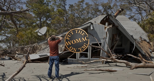 man seeing hurricane damage on his home